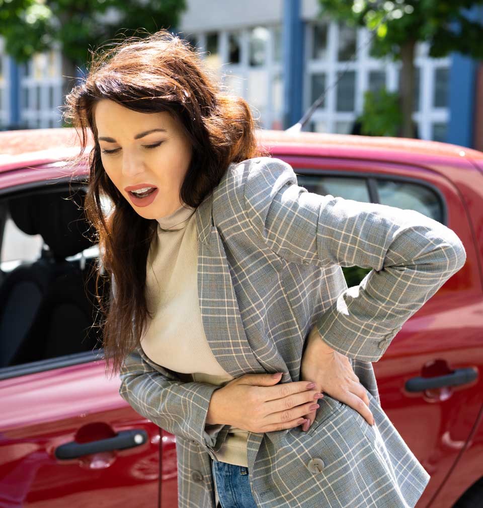 A woman is in need of a Car Accident Chiropractor